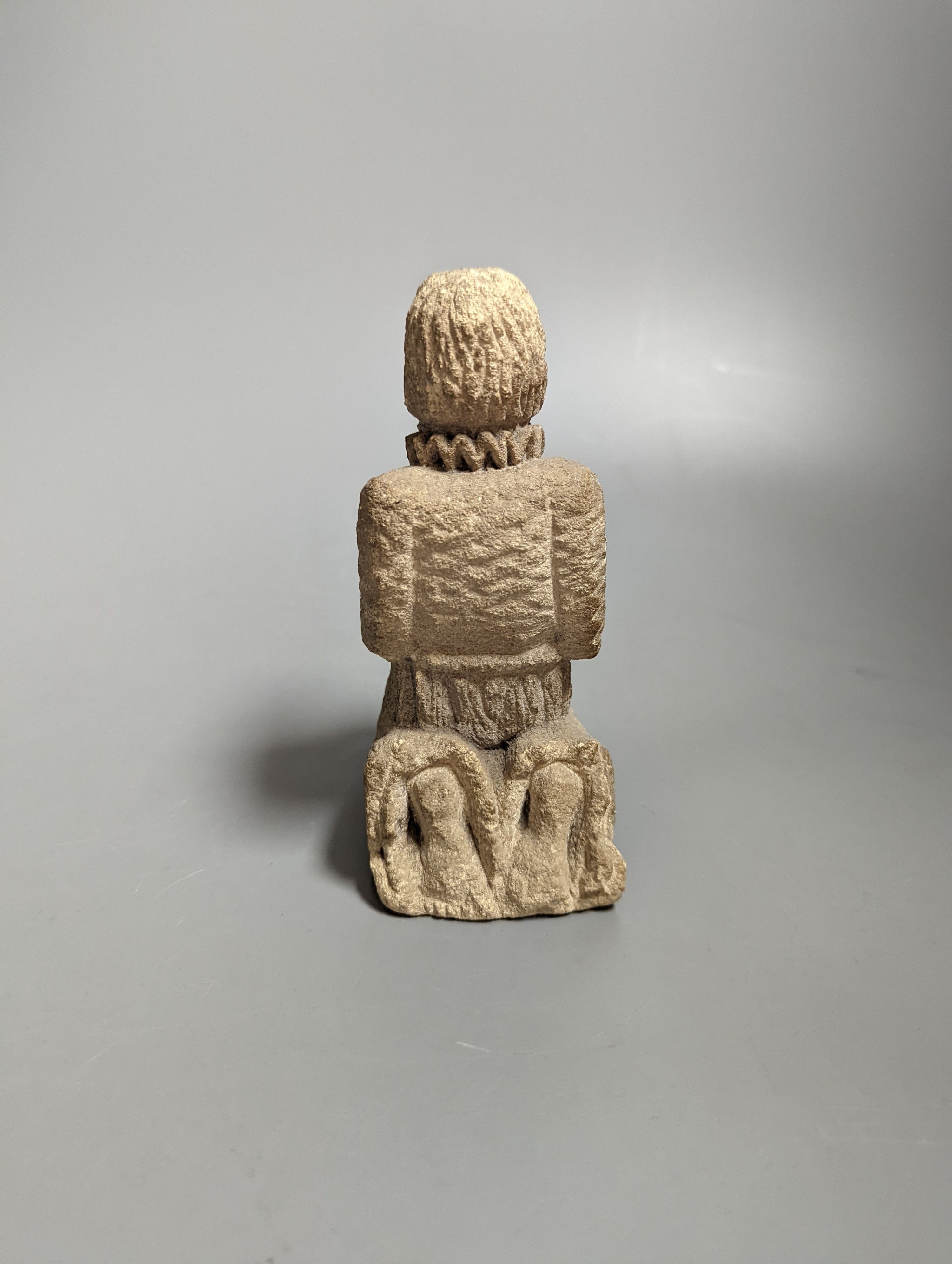 A small carved limestone kneeling/praying chorister, possibly Medieval, 13.5 cms high